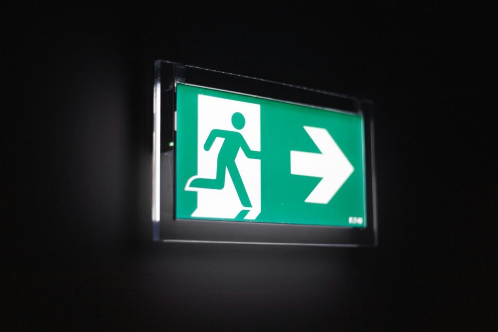 Illuminated green emergency exit sign