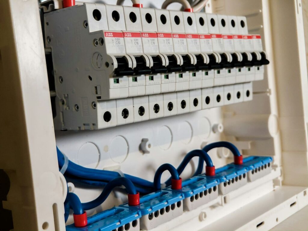 Row of white circuit breakers in a fuse board