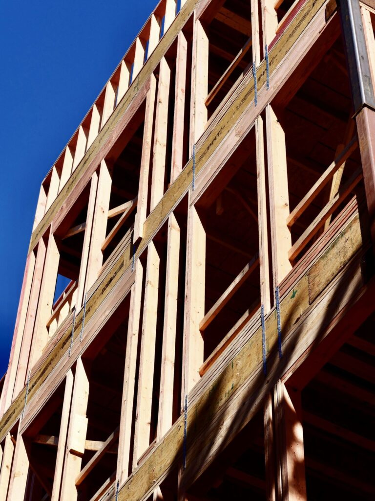 Timber frame of a new home against a blue sky